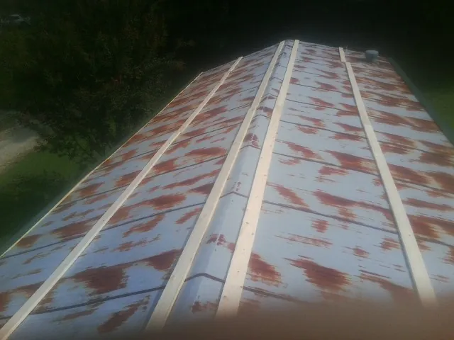 Rusted metal roof panels with new wood purlins before replacement — Storm Damage Roof Repair in Barnwell by Roofing Brothers