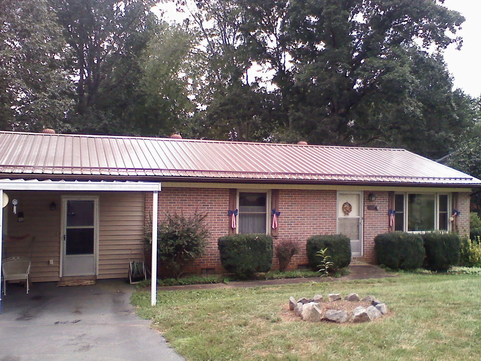 Bronze metal roof and carport on a brick ranch home — Roof Repair work by our crew in Barnwell