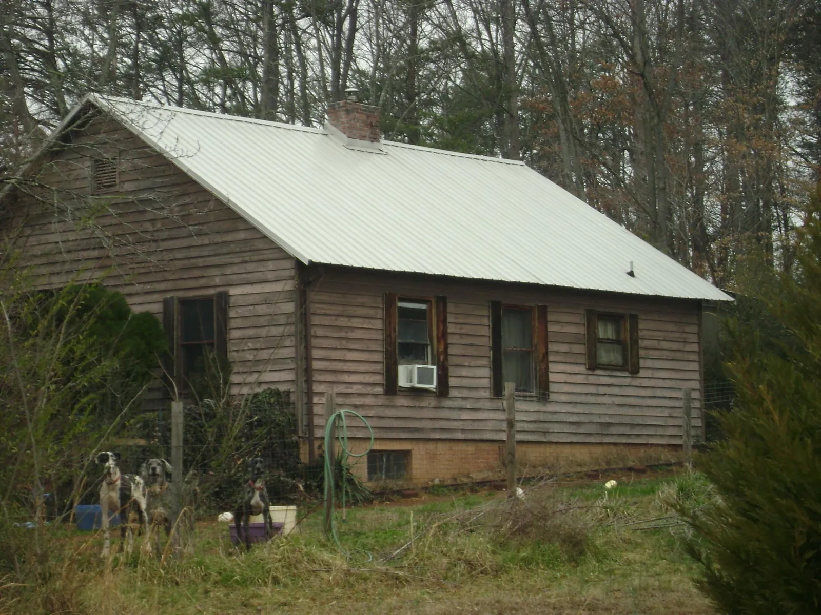 White metal roof on an old wood sided farmhouse, from a Metal Roof Installation job in Barnwell